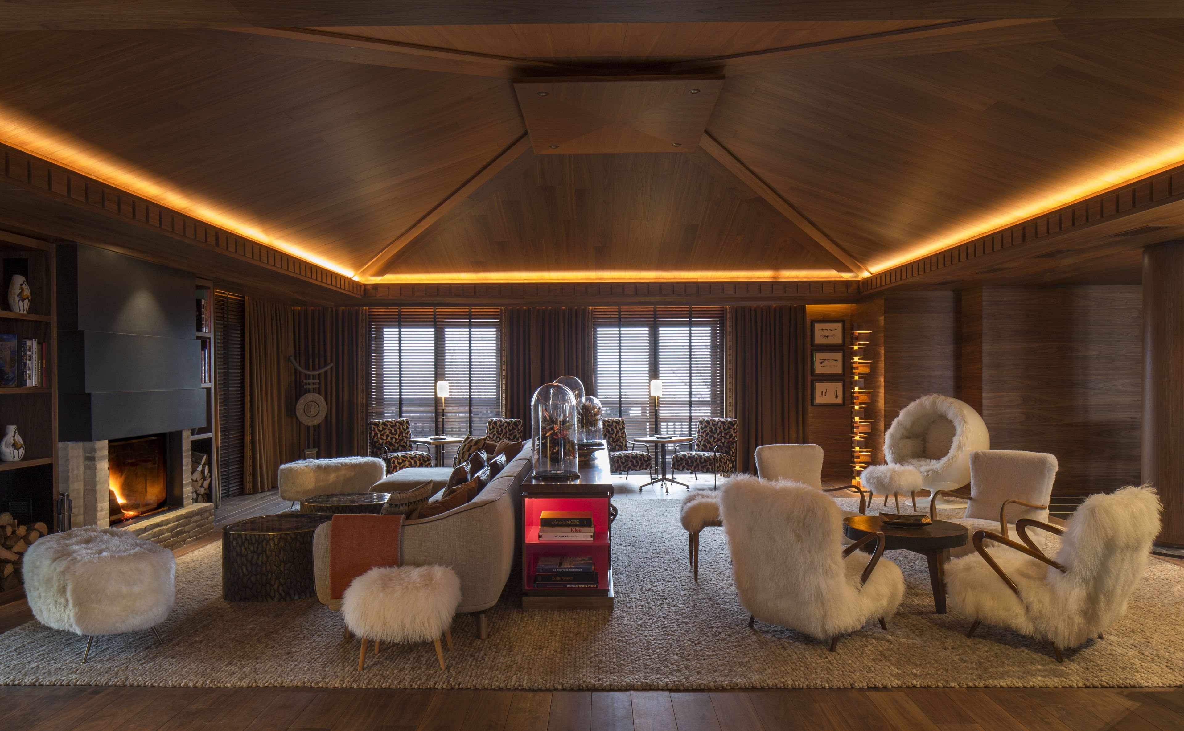 A spacious living room with a fireplace, plush seating, and a modern fireplace unit.