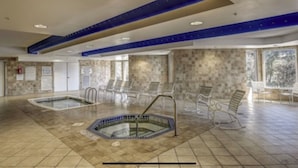 An indoor swimming pool with a hot tub, lounge chairs, and a stone-tiled floor. - 2201 SeaCrest. Renovated 1BR + Bunk Alcove — 2 Full Baths, Sleeps 6 (Hilton Head Island)