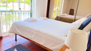 A neatly made bed with white linens and a folded towel on the side. - Villa located in the last condo before arriving the beach of Meco (Sesimbta)