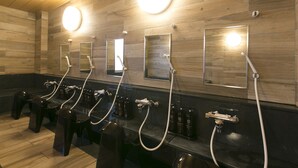 A public restroom with multiple sinks, mirrors, and hand dryers.