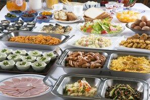 A buffet with various food items including meats, salads, and desserts.