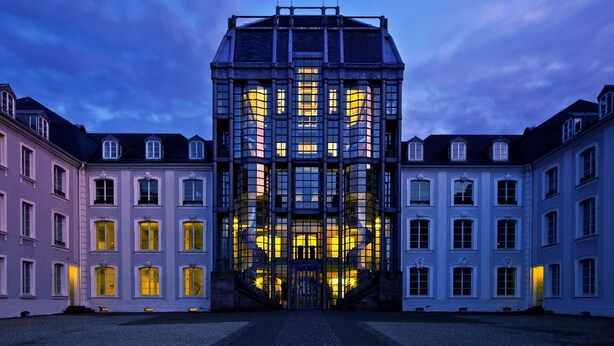 A large, symmetrical building with a central entrance and multiple windows.