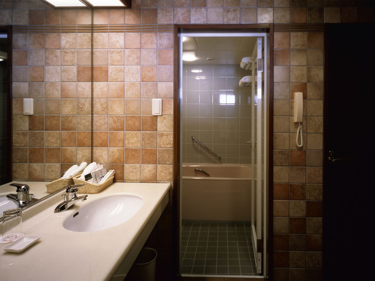 A bathroom with two sinks, a bathtub, and a shower.