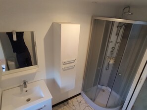 Shower, hair dryer, towels, toilet paper