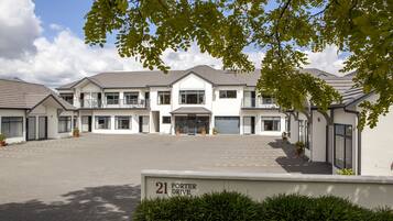 A modern building with a large driveway and a sign indicating 'Porter Drive'.