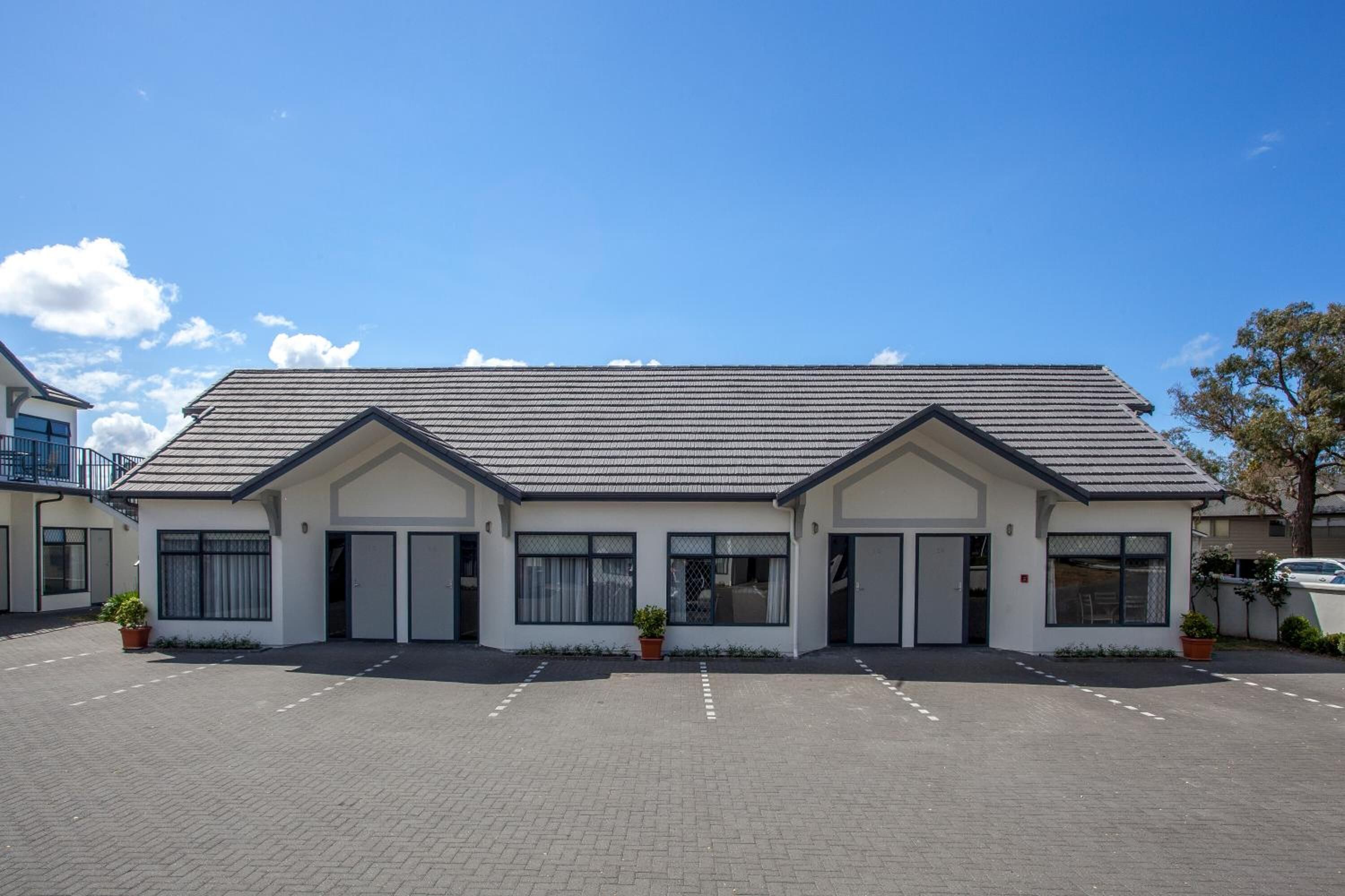 A modern building with a flat roof and large windows.