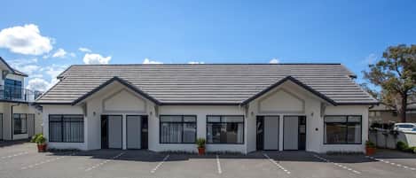 A modern building with a flat roof and large windows.