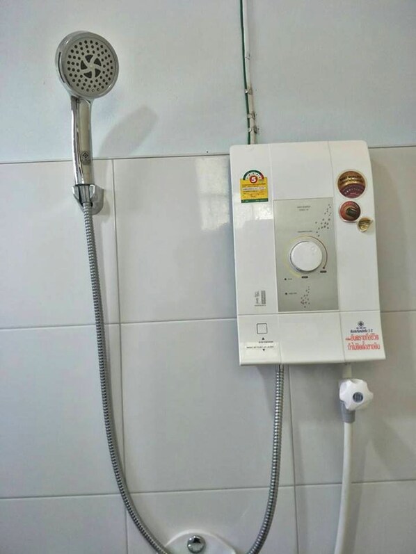 A wall-mounted shower unit with a handheld showerhead and a control panel. - Golden Dragon Resort (Kanchanaburi)