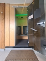 A wooden interior with a sign reading "PHYSIO THERM Infrarotkabinen".
