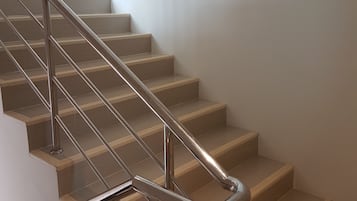 A staircase with metal handrails and wooden steps.
