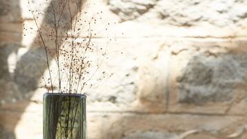 Two glass vases with branches on a wooden table.