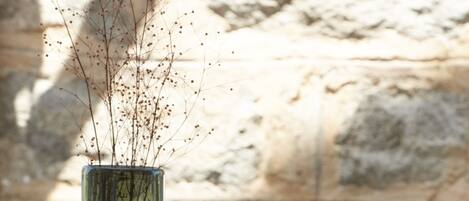 Two glass vases with branches on a wooden table.
