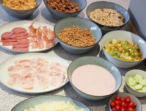 A variety of food items including meats, fruits, and grains on a countertop. - Hotel Goldene Rose (Brunico)