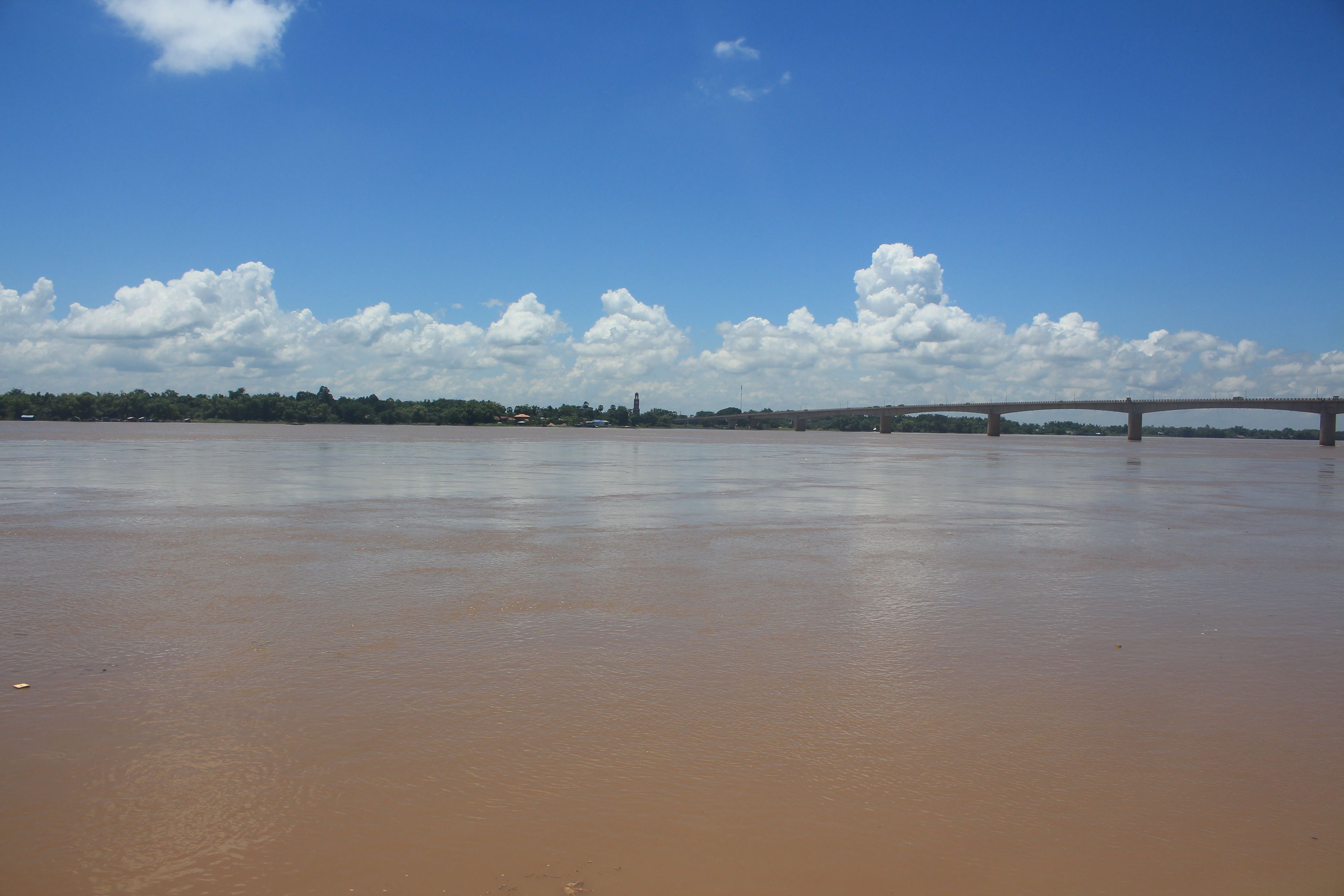 A river with a bridge in the background.
