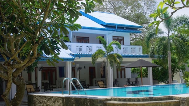 A two-story building with a swimming pool, outdoor seating, and a stone staircase leading to the pool. - Ariyana Wellness Retreat Yala (Thissamaharama)