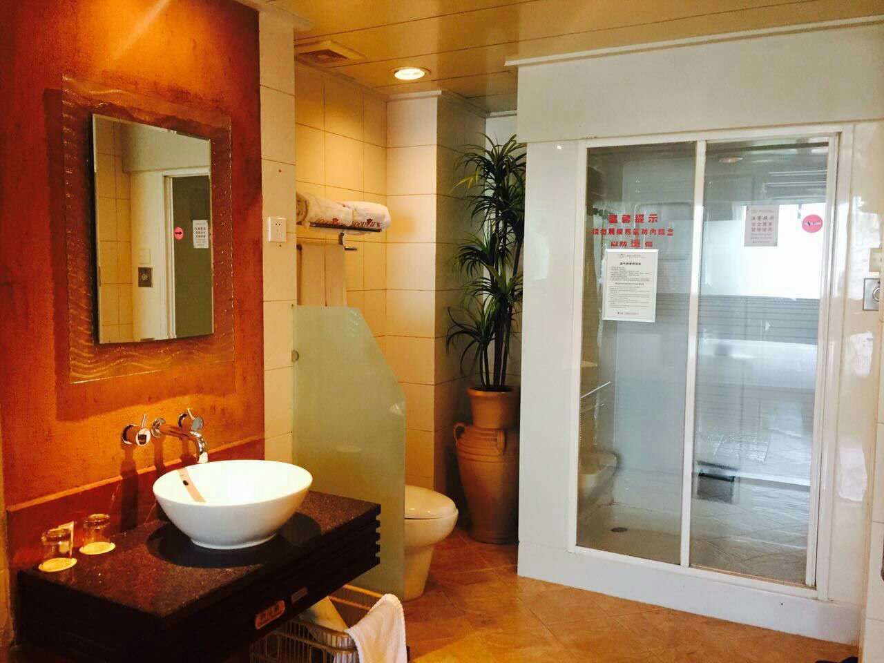A bathroom with a white sink, a mirror, a towel rack, and a toilet.