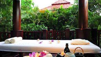 Relax in a serene setting with a comfortable bed, surrounded by lush foliage and natural ambiance.