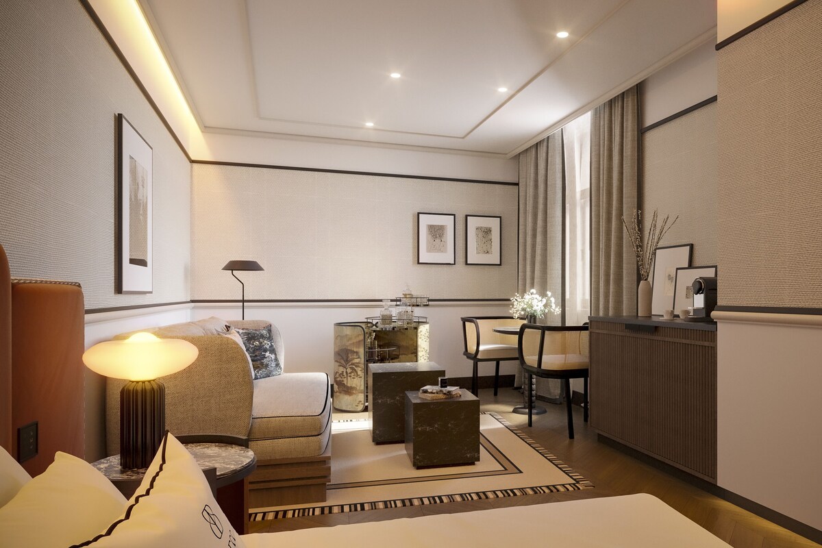 Uma sala de estar moderna com sofá, mesa de centro, área de jantar com cadeiras e lareira.