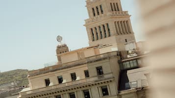 A multi-story building with classical architecture, including columns and a clock on the tower.