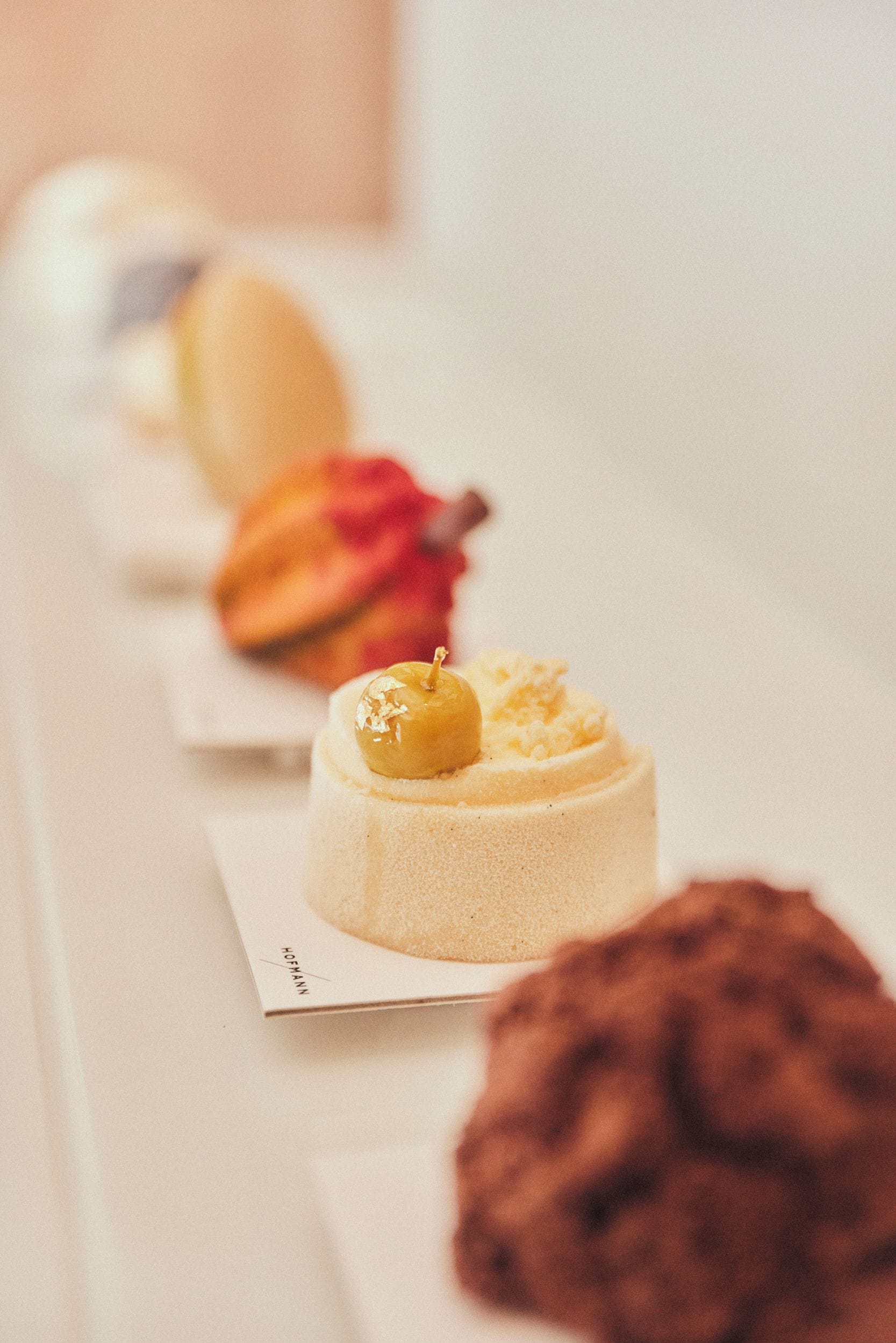 A dessert table with various cakes and pastries.