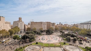 A large public square with a central fountain, surrounded by trees and buildings. - BLESS Barcelona - New Opening 2026  (Barcelona)