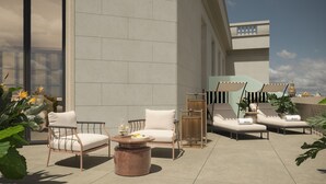 A rooftop lounge with outdoor seating, a coffee table, and potted plants. - BLESS Barcelona - New Opening 2026  (Barcelona)