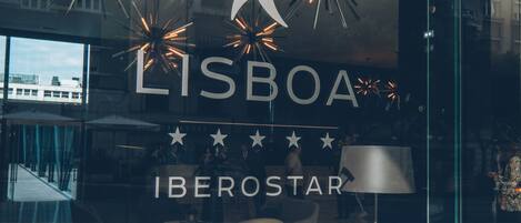 A glass window with the text "LISBOA IBEROSTAR" and a star rating of 5 stars.