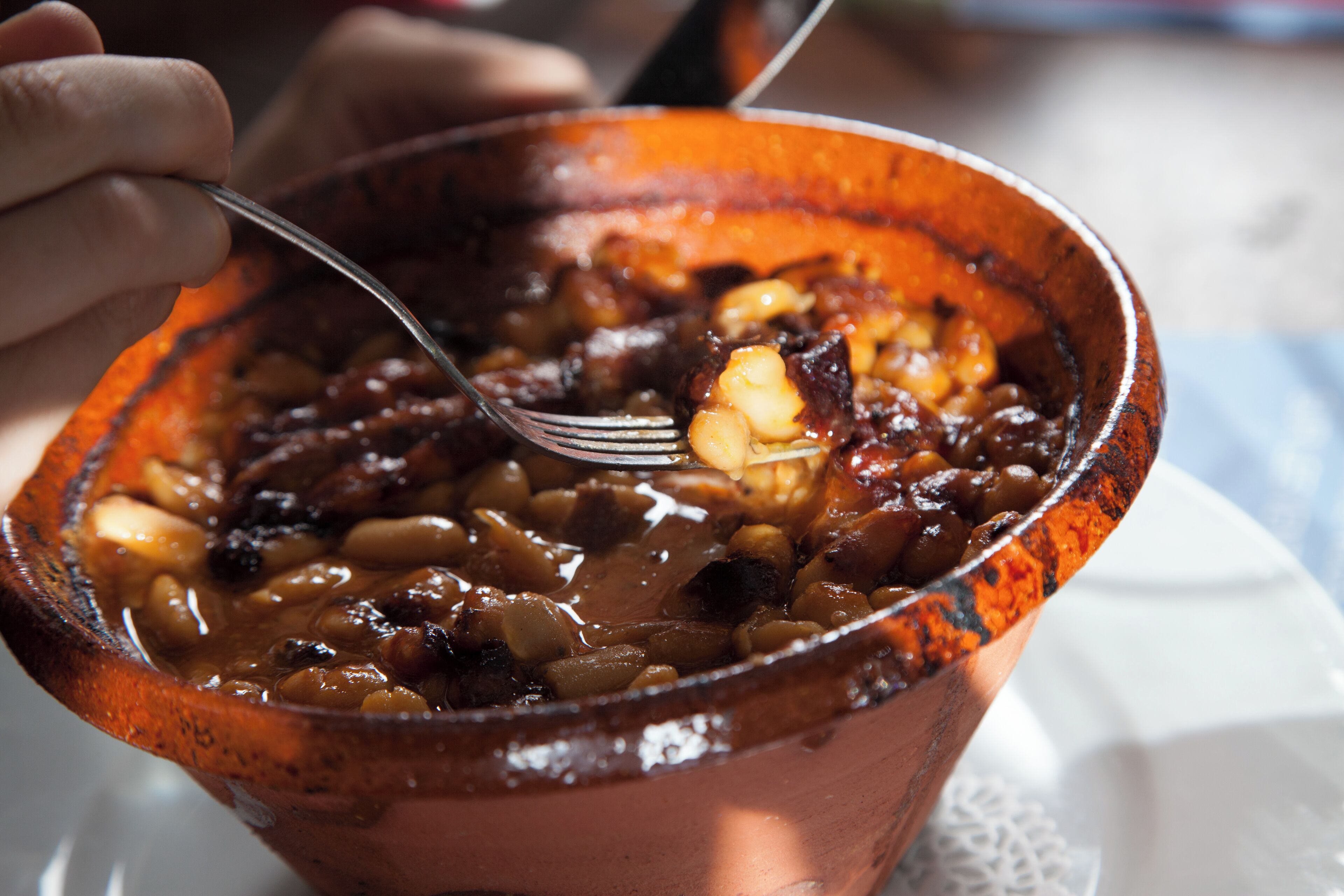 A bowl of beans with a fork.