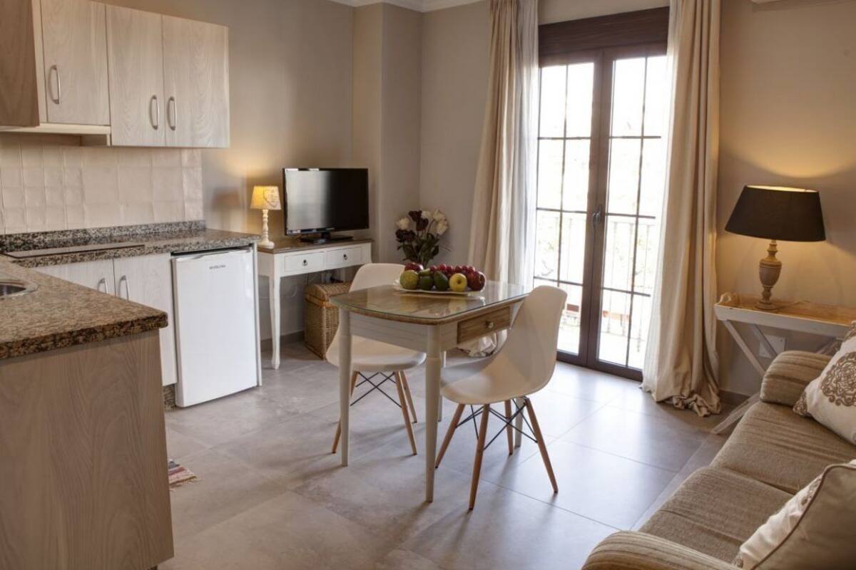 A compact living space with a kitchenette, dining area, and a sofa.