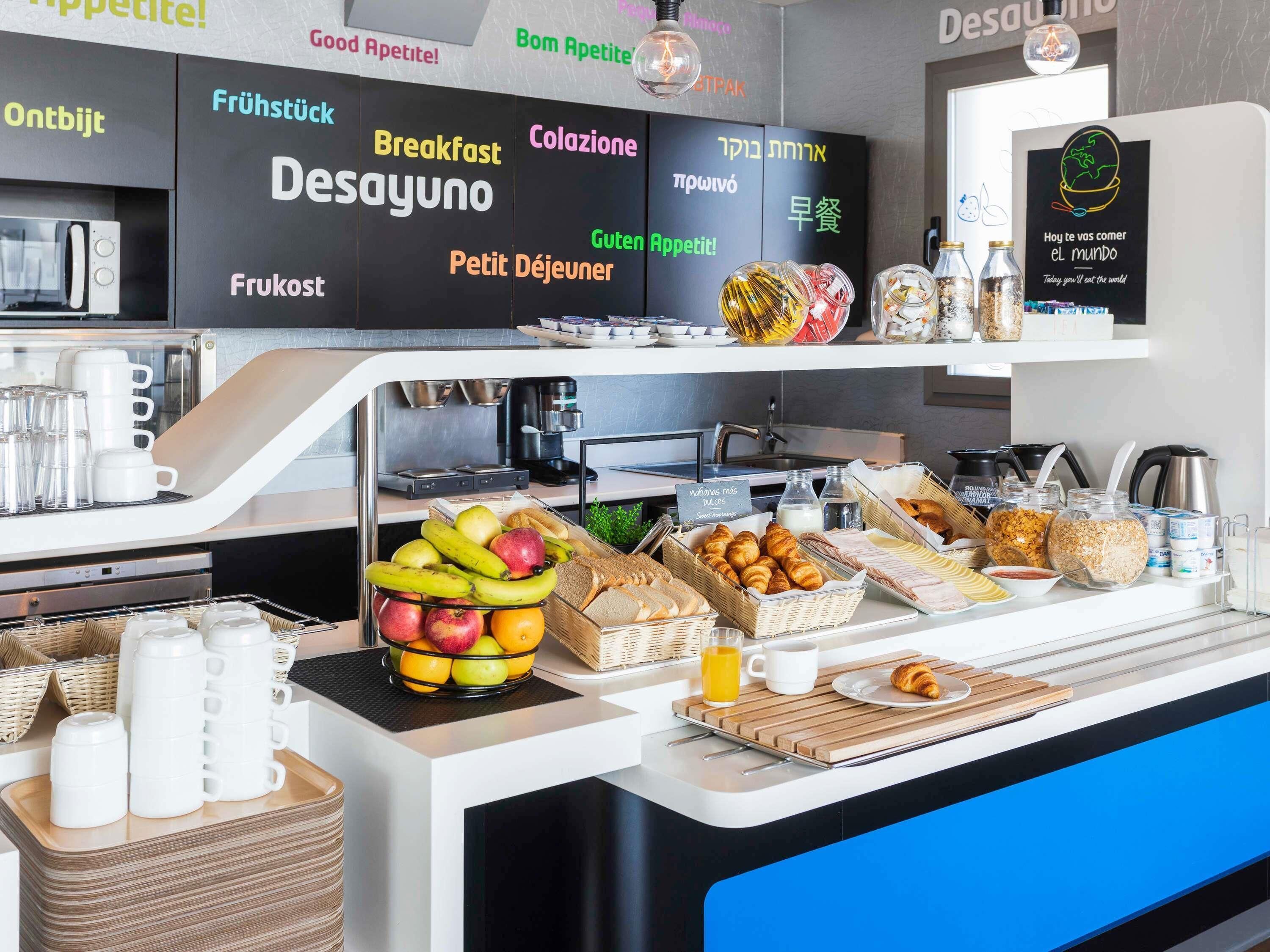 A breakfast buffet with various food items and a coffee station.