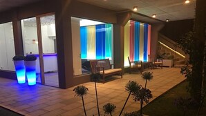 A hotel lobby with a reception area, seating, and a staircase. - Solar Pampa Apart Hotel (Mar de Las Pampas)