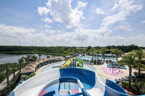 A water park with a large wave pool, lounge areas, and a view of the lake. - Balmoral Resort Florida (Haines City)