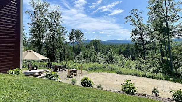 A backyard with a picnic table, chairs, and a barbecue grill. - 10 Min to Sunday River, Sleeps 16, Pool Heated Year-Round, Mountain Views (Bethel)