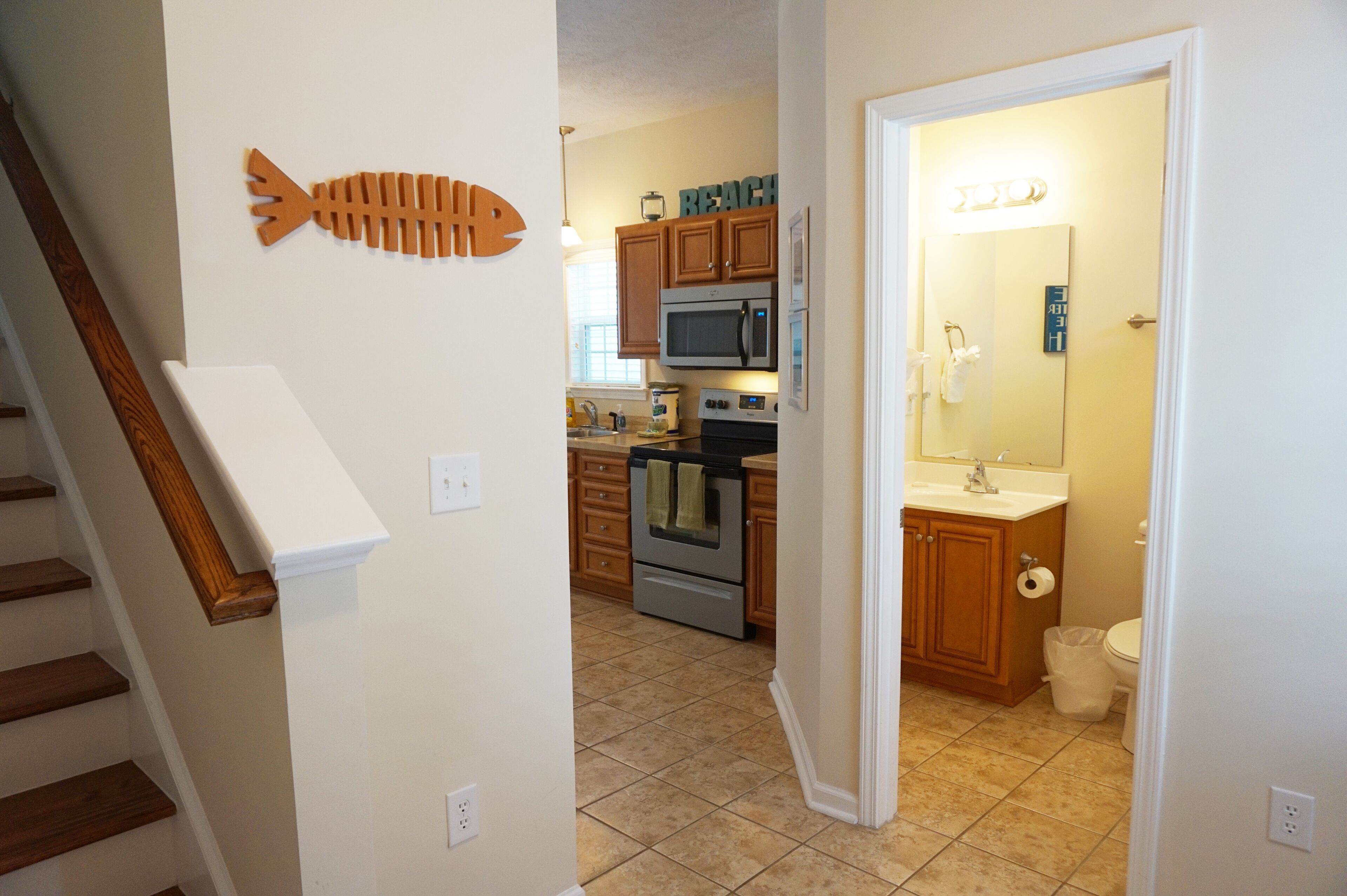 A kitchen with wooden cabinets, a microwave, and a stove.