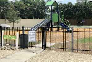Explore the playground at Lou Barolo South Park, featuring a slide and climbing structures.