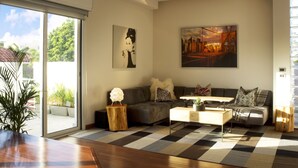 Una sala de estar moderna con sofá, mesa de centro y obras de arte en las paredes.