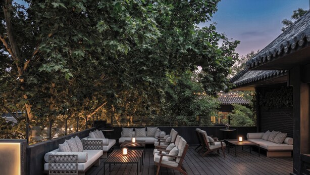 A wooden deck with outdoor seating, including sofas and chairs, and a small table. - Blossom House Prince Kung's Mansion · Beijing Houhai (Beijing)