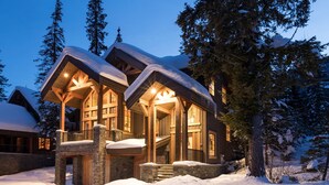 A log cabin with a stone foundation, wooden exterior, and a snow-covered roof. - Hiking,biking,skiing, family reunion or trip to a national park we have it all!! (Golden)