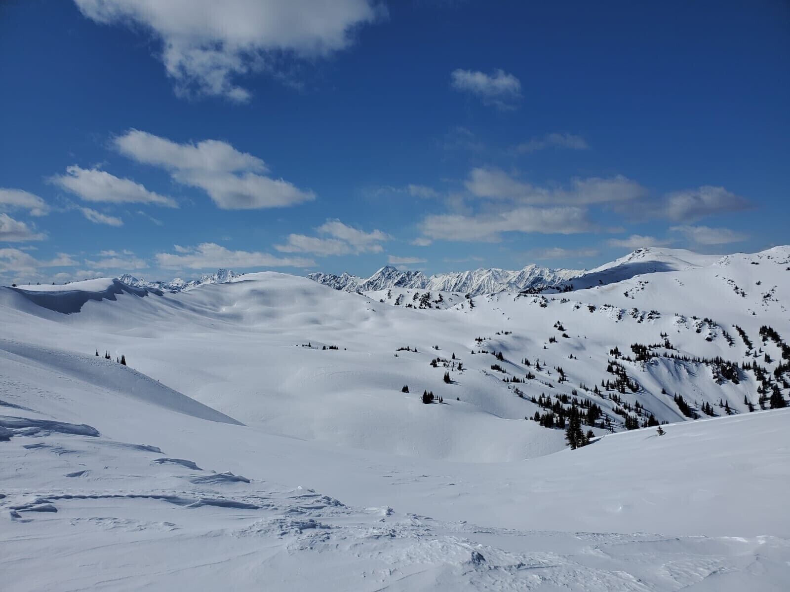 A snow-covered mountain landscape with clear skies.