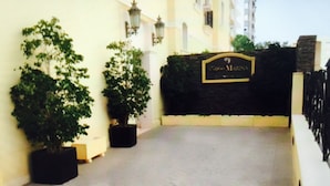 A paved walkway leading to a building with a sign reading "Hotel Marina." - Design apartment, with a private terrace of 140 meters 20 meters from the sea and parking (Aguilas)