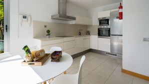 A modern kitchen with white cabinetry, a built-in oven, and a microwave. - Bali Sky Villa with Private Pool (San Bartolomé de Tirajana)