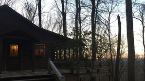 A rustic cabin with a wooden staircase leading to a porch, surrounded by trees. - Secluded cabin in Aska Adventure Area  (Blue Ridge)