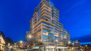 A multi-story hotel with a modern design, featuring balconies on each floor and a prominent entrance with a glass facade. - The Falls: The Waterfalls Hotel: Luxury Oasis at the Falls in Victoria, BC (Victoria)