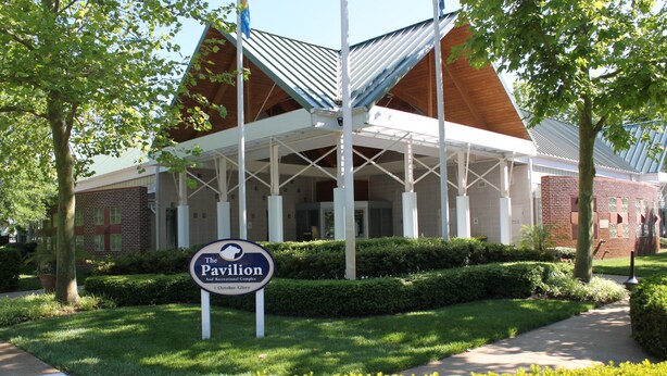 A building with a covered entrance and a sign that reads "The Pavilion And Recreational Complex." - Coastal Greens Getaway-3 BR Golf Villa.  Plan now for a fall getaway! (Ocean View)