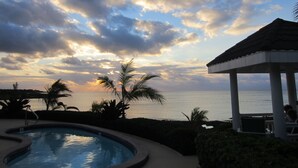 A pool with a view of the sea and a gazebo. - Secluded Waterfront Single Family Villa with Private Pool – 3,000 Sq of Luxury (East End - Half Moon Bay)
