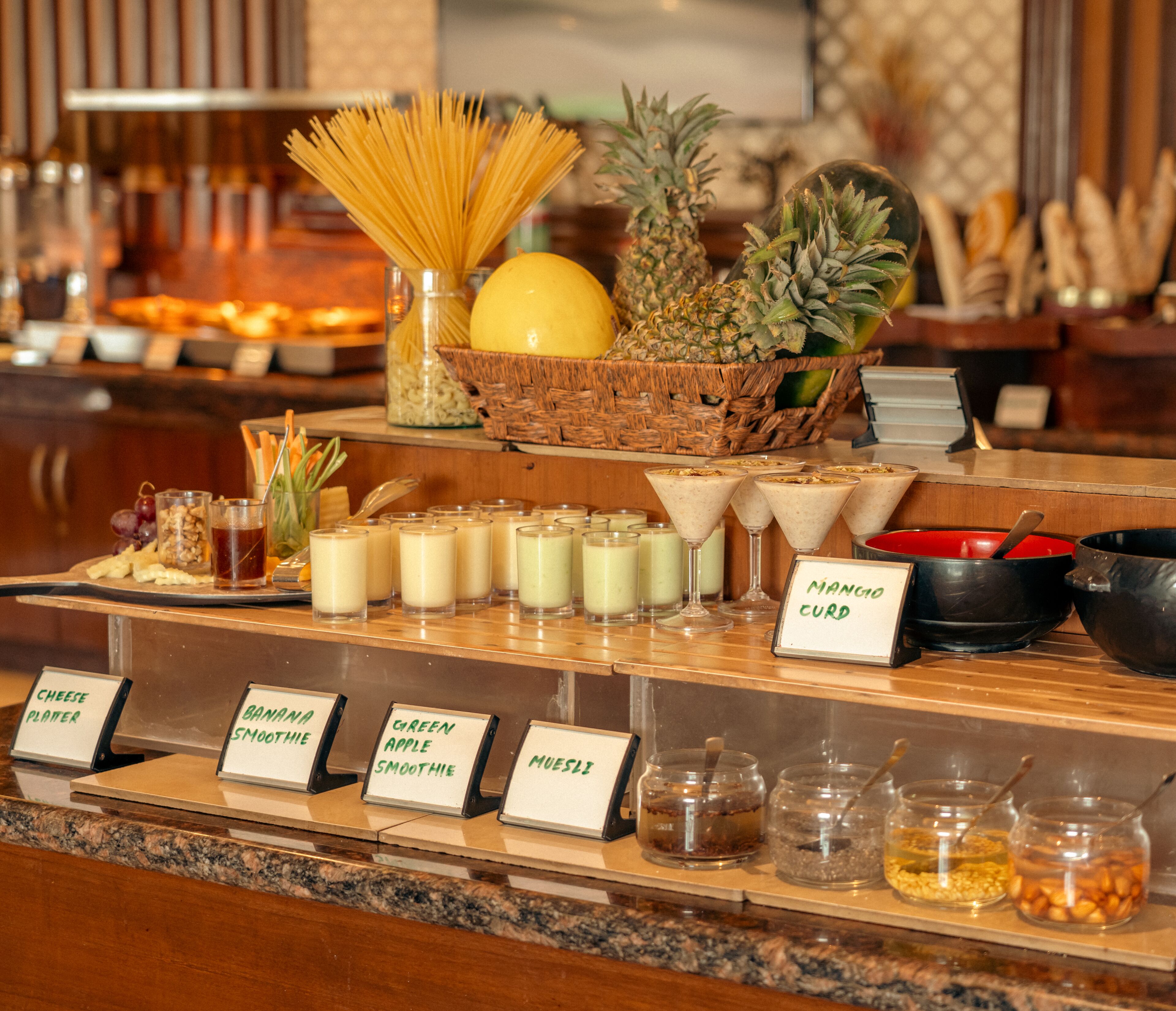 A buffet with various food items and labels for different dishes.