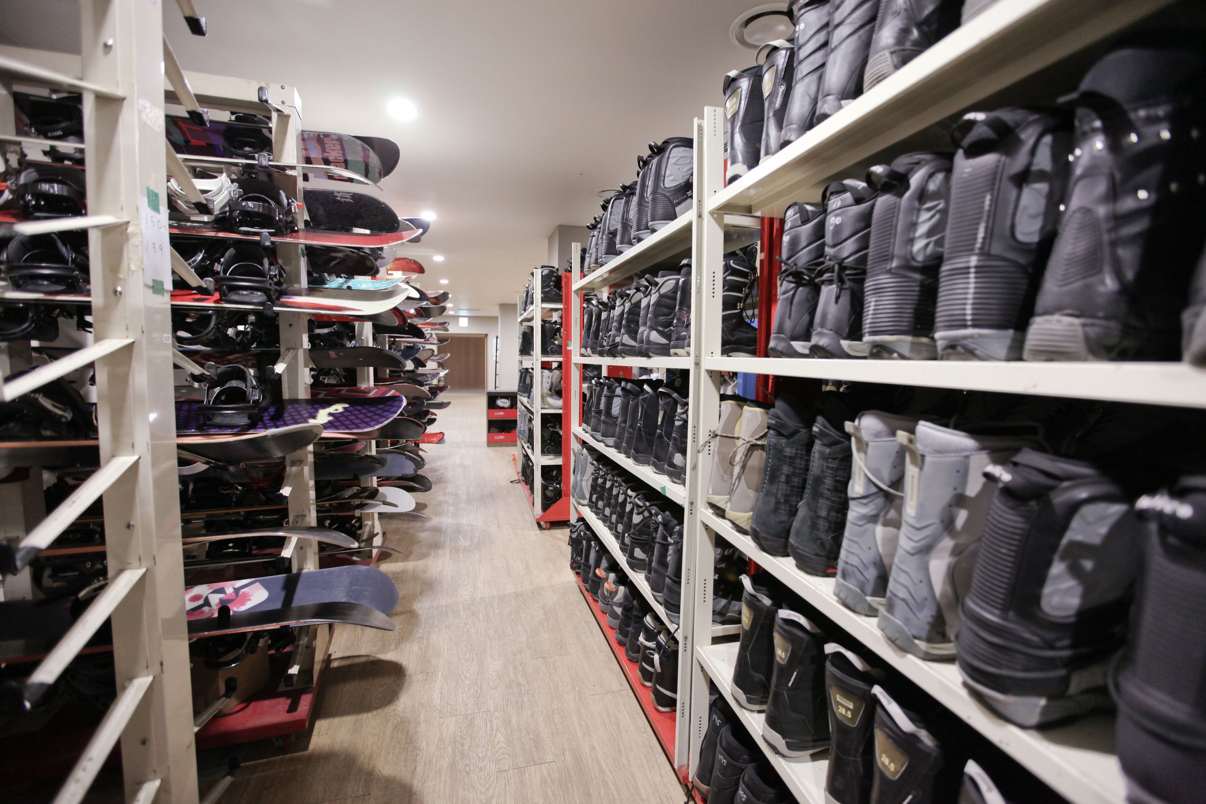 A shoe store with shelves stocked with various types of footwear.