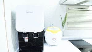 A water dispenser and a coffee machine in a modern kitchen setting. - JW STAY in HONGDAE - Hostel (Seoul)