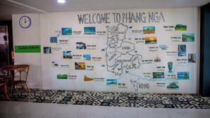 A wall with a map of Phang Nga, including labeled locations like Koh Tao and Koh Samui.