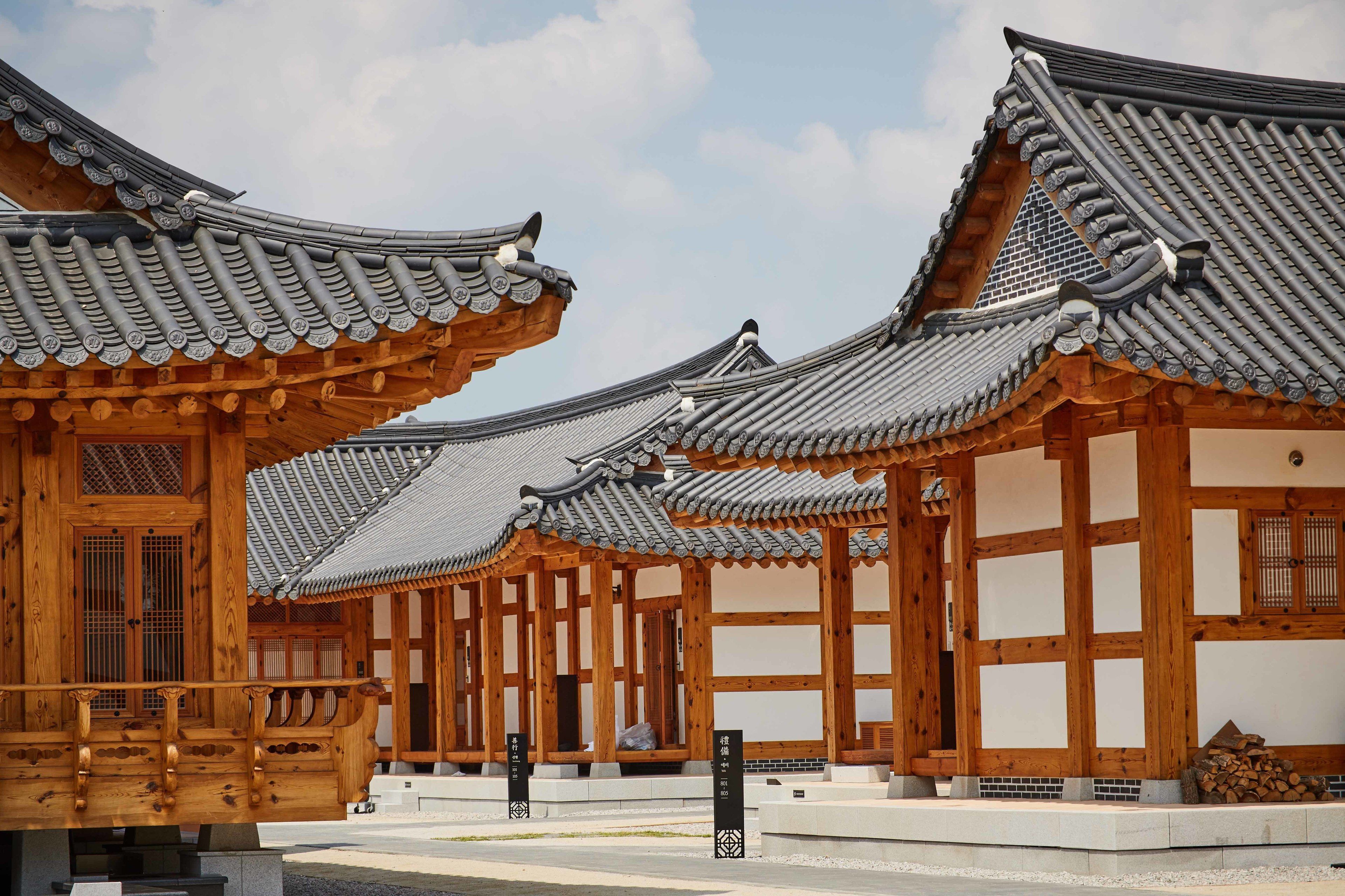 A traditional wooden building with multiple tiled roofs and wooden beams.